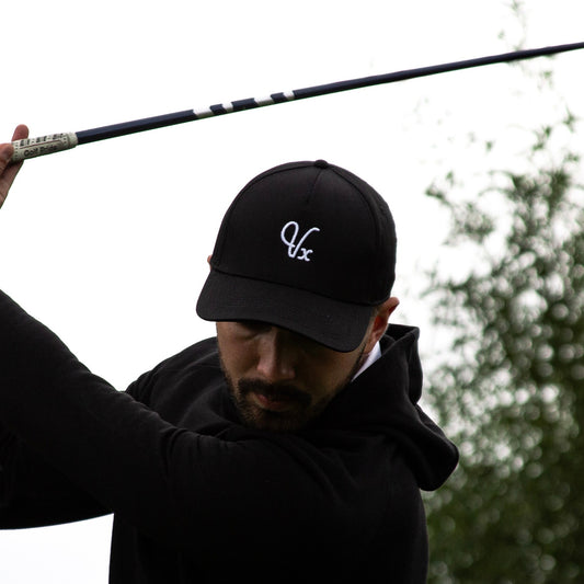 Vintxge Black Golf Cap, mid-swing